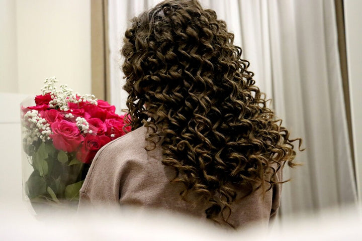 person wearing a curly wig